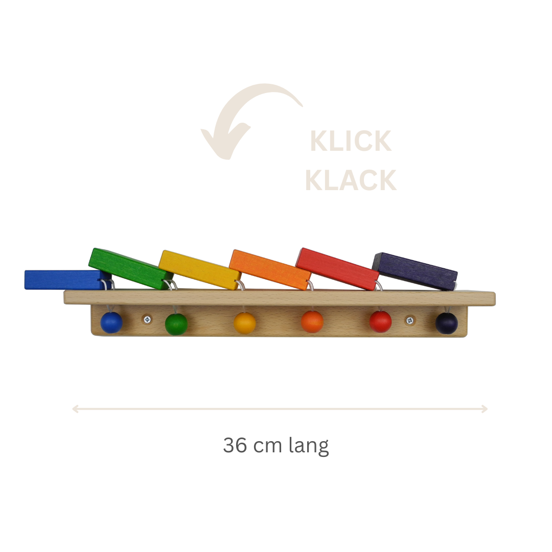 FRIDLIN Wanddomino mit 6 bunten Holzsteinen – montessori-inspiriertes Lernspielzeug zur Förderung von Feinmotorik und Ursache-Wirkung-Verständnis.